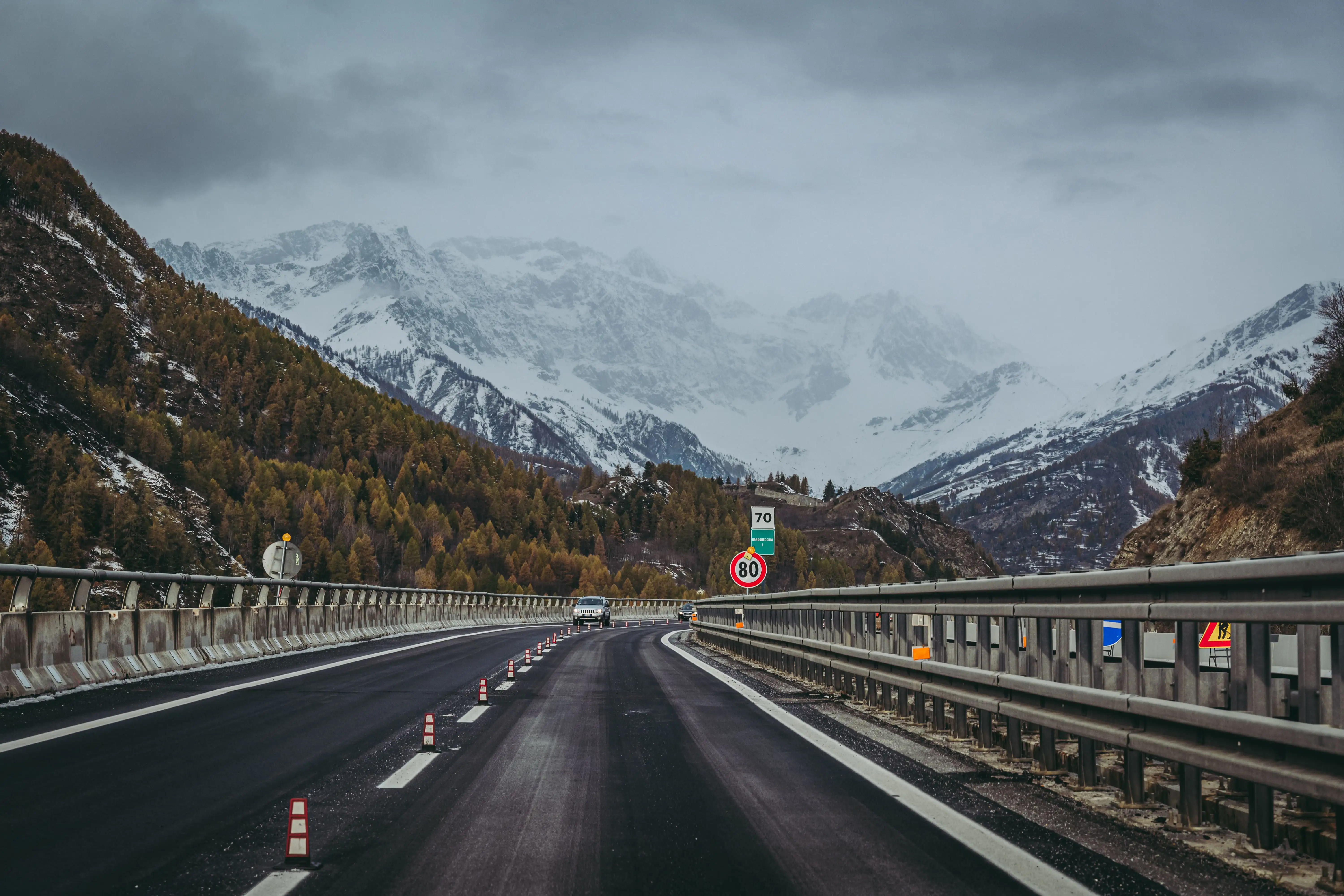 View of a road and a snowy range of mountains ahead