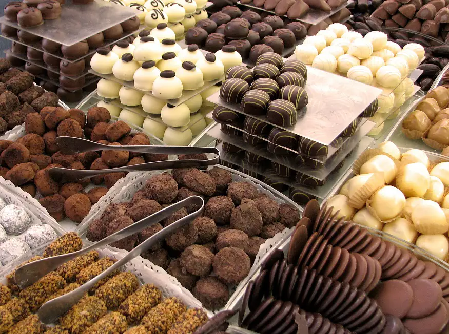 A beautifully arranged display of assorted chocolates in various shapes and colours