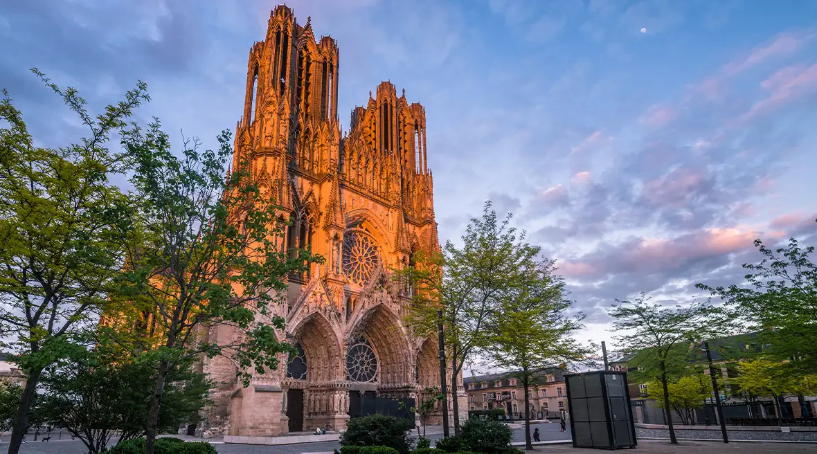 A Gothic cathedral with two towers at sunset