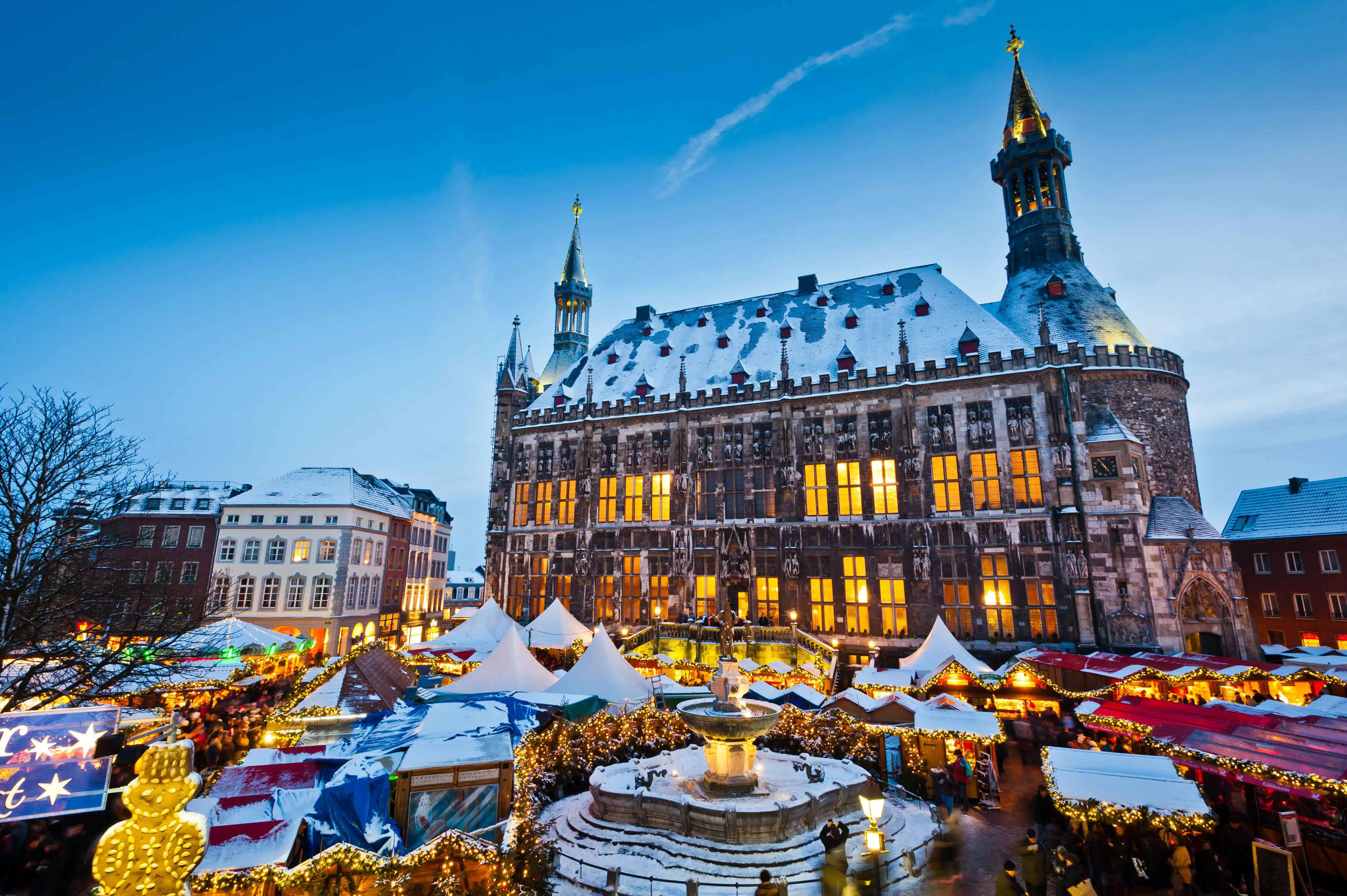 A city square with Christmas market stalls