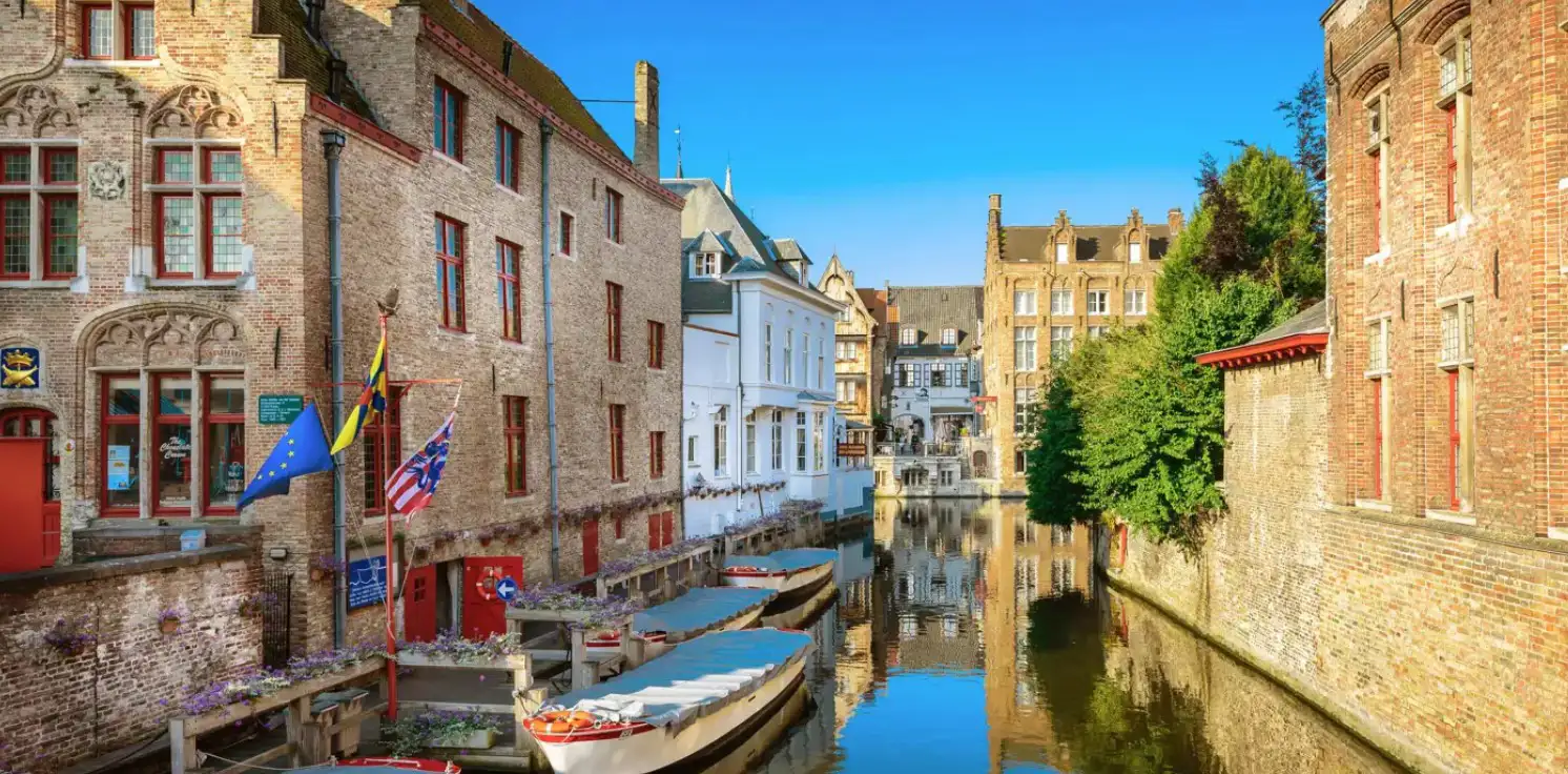 Waterside buildings of a historic European city, with boats moored up on a canal